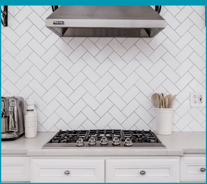 White herringbone tile backsplash